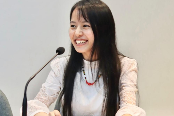 Florence Laldinpuii smiling in front of a microphone